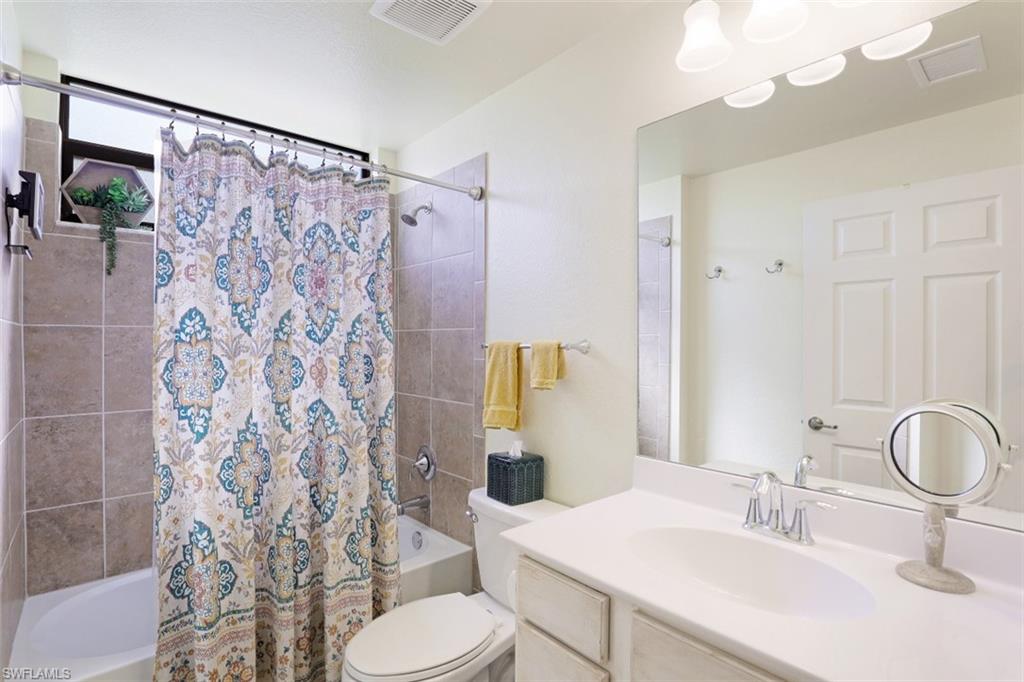 9533 Avellino Way, Unit 2916 Naples, FL 34113 - Photo 18 of 23 a bathroom with a sink toilet and shower