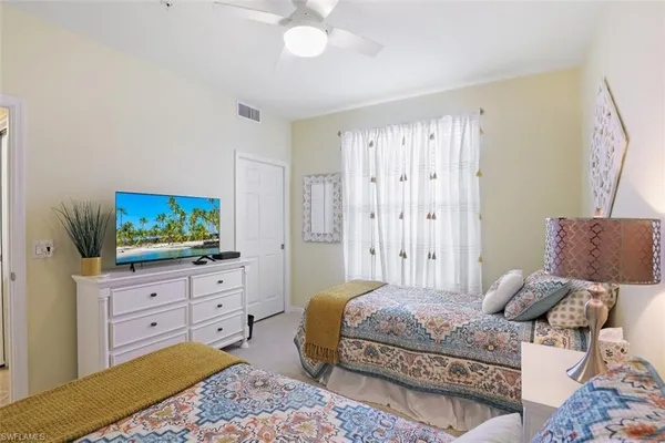 a bedroom with a bed and a television