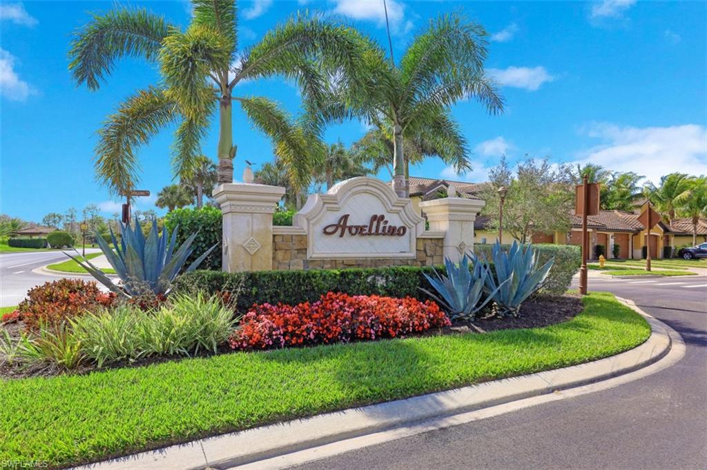 9533 Avellino Way, Unit 2916 Naples, FL 34113 - Photo 23 of 23 a front view of a house with a garden and trees
