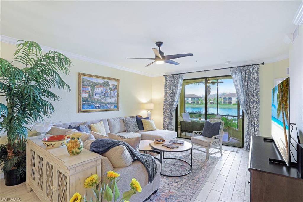 9533 Avellino Way, Unit 2916 Naples, FL 34113 - Photo 3 of 23 a living room with furniture and a flat screen tv