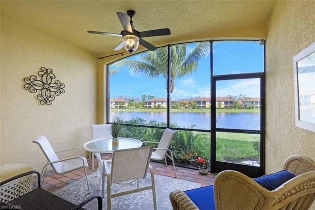 a dining room with furniture a flat screen tv and a large window
