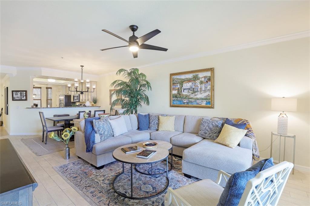 9533 Avellino Way, Unit 2916 Naples, FL 34113 - Photo 5 of 23 a living room with furniture and a chandelier