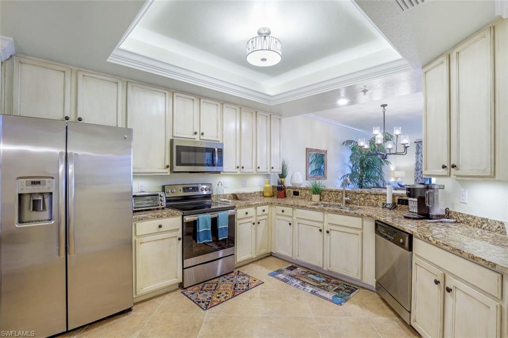 9533 Avellino Way, Unit 2916 Naples, FL 34113 - Photo 8 of 23 a kitchen with a sink stove and refrigerator