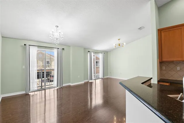 a view of a kitchen with a sink and wooden floor