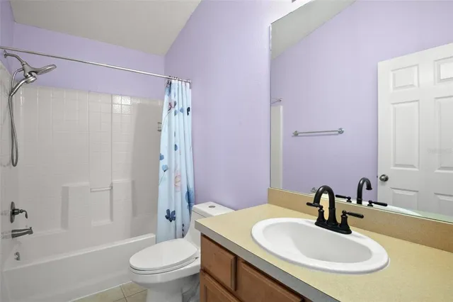 a bathroom with a sink toilet tub vanity and shower