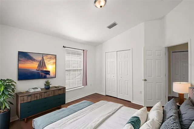 a bedroom with furniture and a flat screen tv
