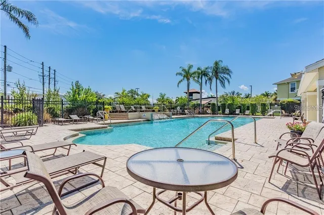 a view of a swimming pool and outdoor seating