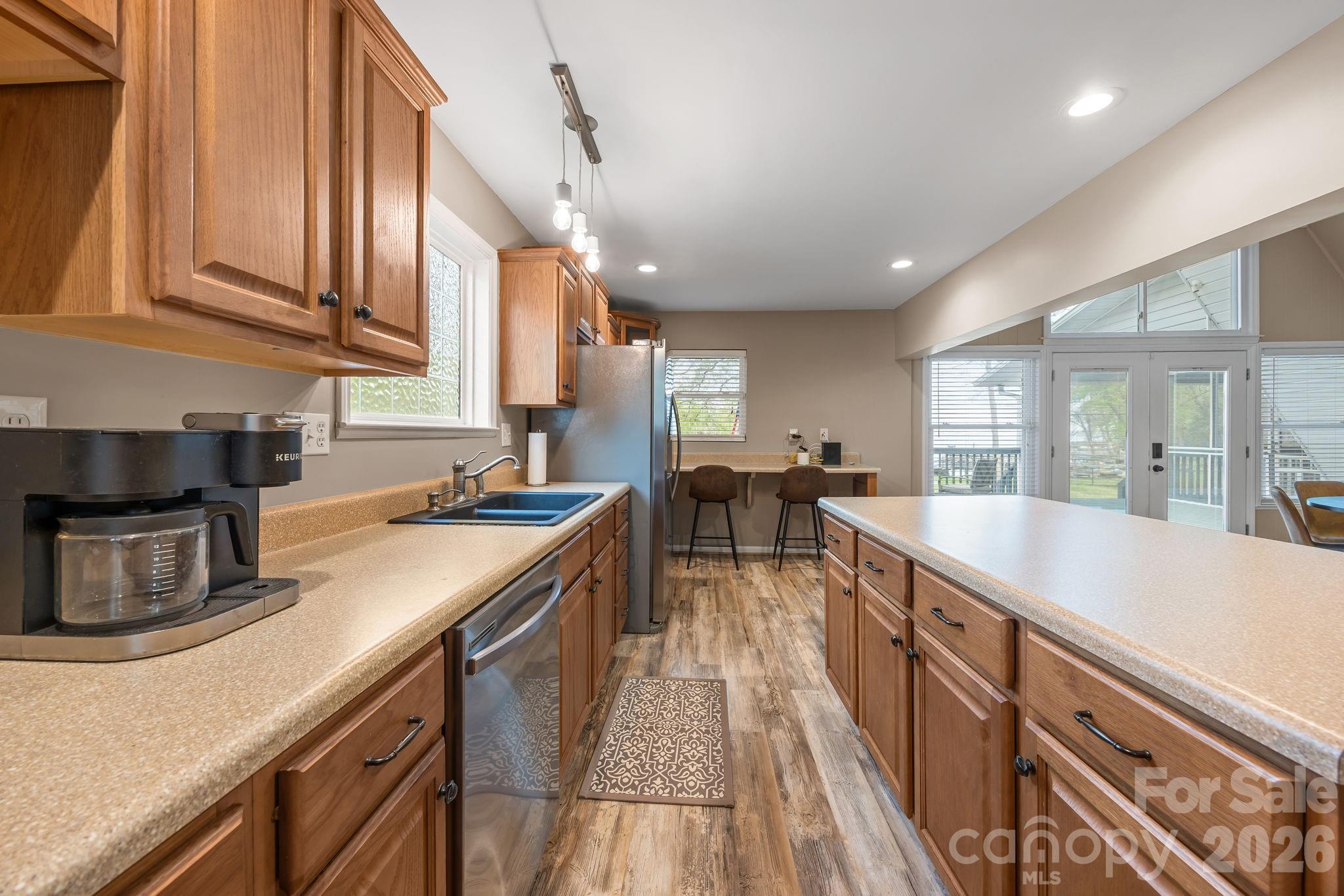 1870 Scout Road Salisbury, NC 28146 - Photo 20 of 48 a large kitchen with stainless steel appliances granite countertop a lot of counter space and wooden floors