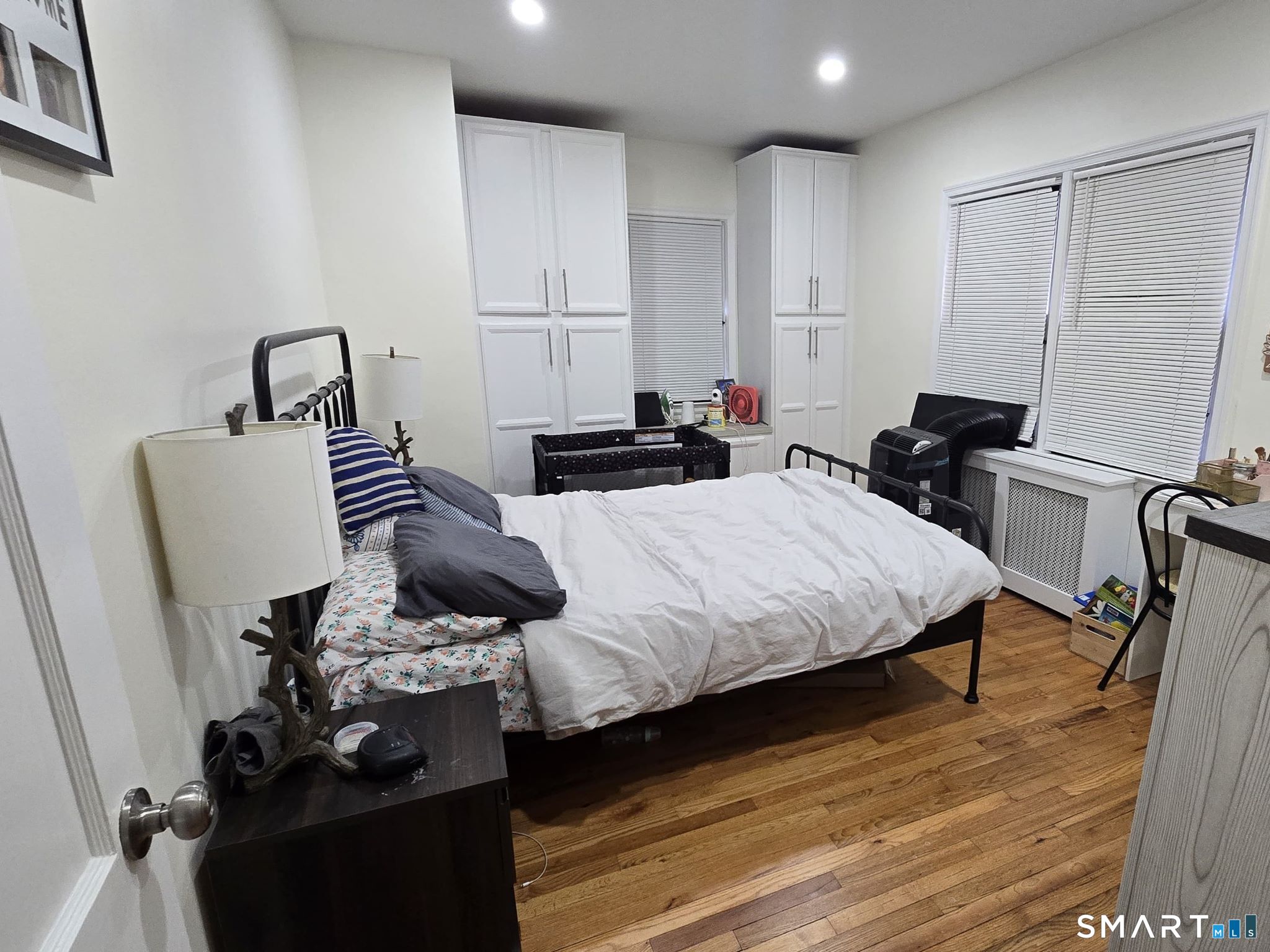 73 Rippowam Road Stamford, CT 06902 - Photo 15 of 19 a bedroom with furniture and a wooden floor
