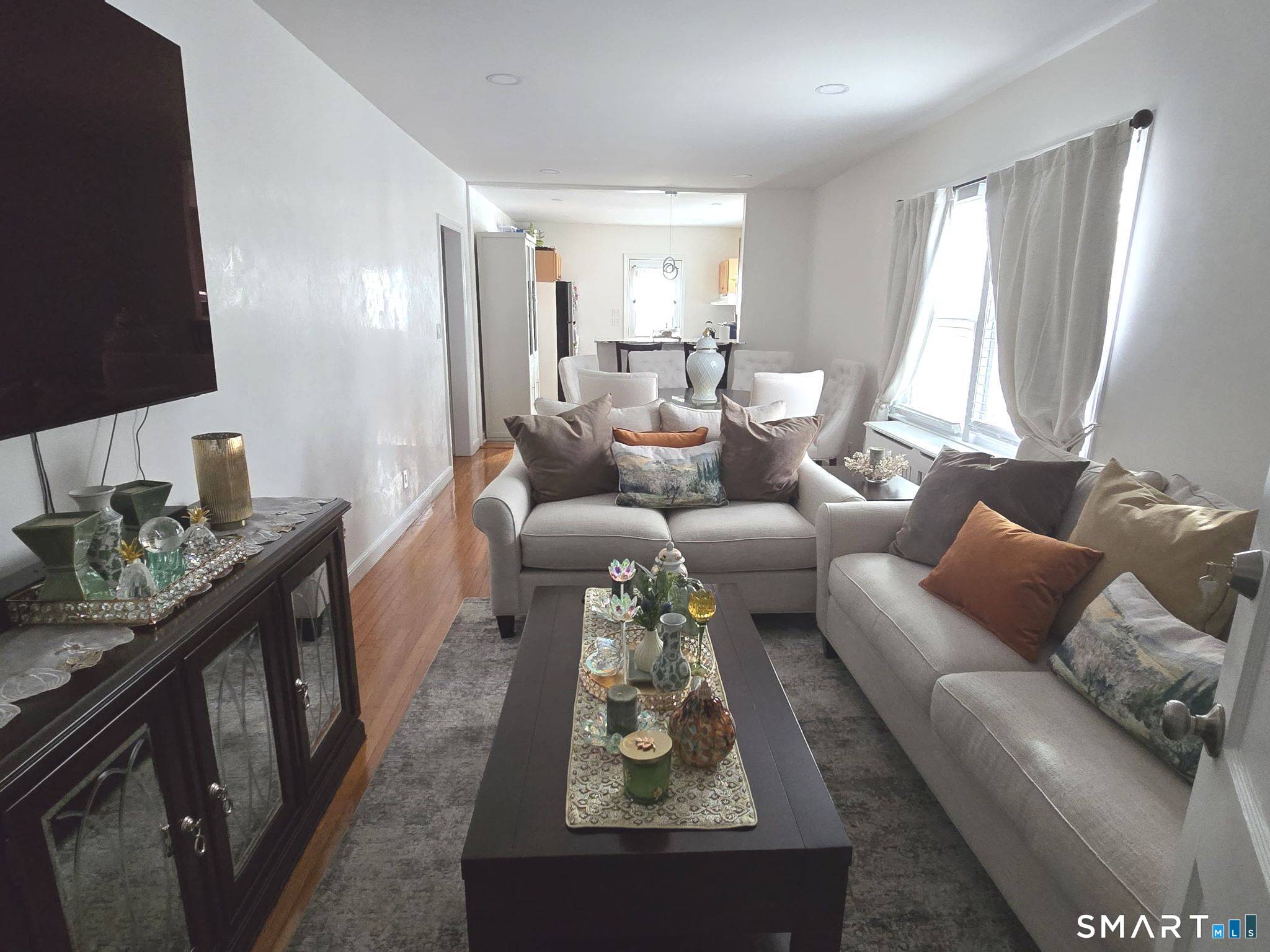 73 Rippowam Road Stamford, CT 06902 - Photo 3 of 19 a living room with furniture and a flat screen tv