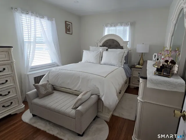 a bedroom with bed couch and window