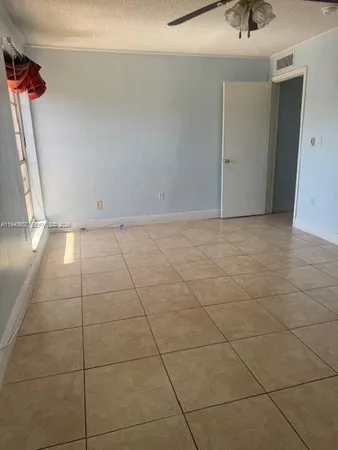 a view of a livingroom with an empty space and a sink window
