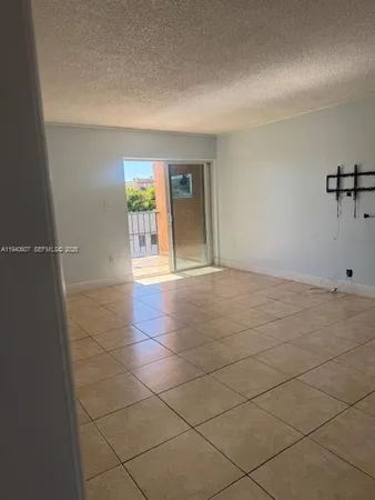 a view of an empty room and a window