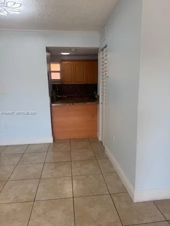 a view of hallway with a window and a kitchen