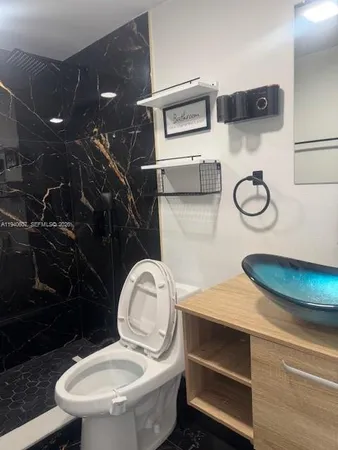a bathroom with a toilet and a sink