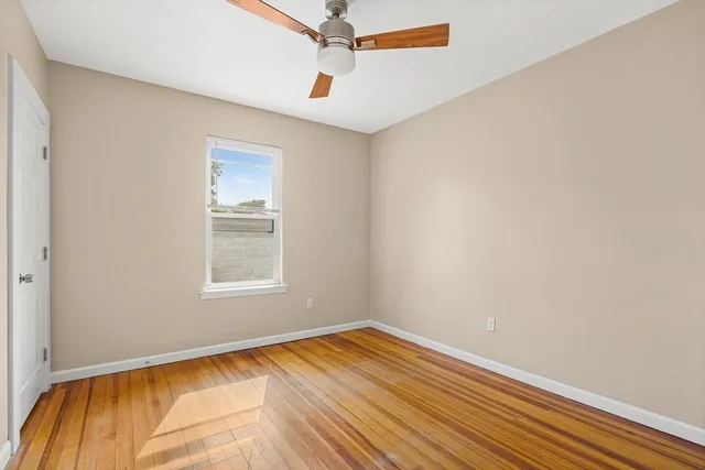 a view of a room with wooden floor and white walls