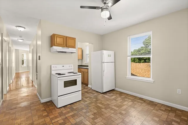 a kitchen with a stove a refrigerator and a microwave