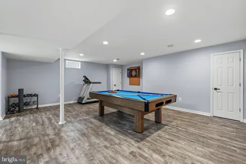 a bedroom with furniture and wooden floor