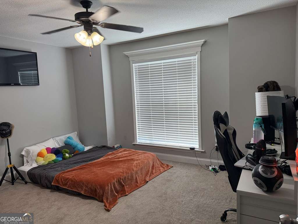 5255 Carlton Ridge Circle Hahira, GA 31632 - Photo 14 of 21 a bedroom with a bed and a chandelier