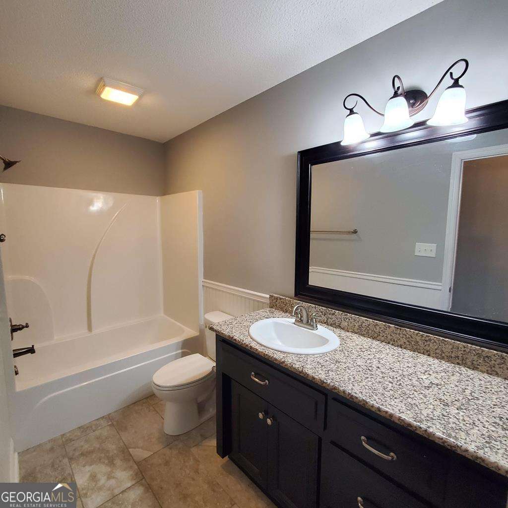 5255 Carlton Ridge Circle Hahira, GA 31632 - Photo 15 of 21 a bathroom with a granite countertop sink toilet and shower