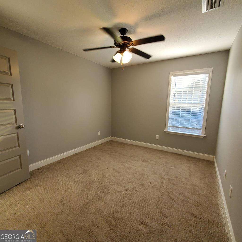 5255 Carlton Ridge Circle Hahira, GA 31632 - Photo 18 of 21 an empty room with a window and a fan