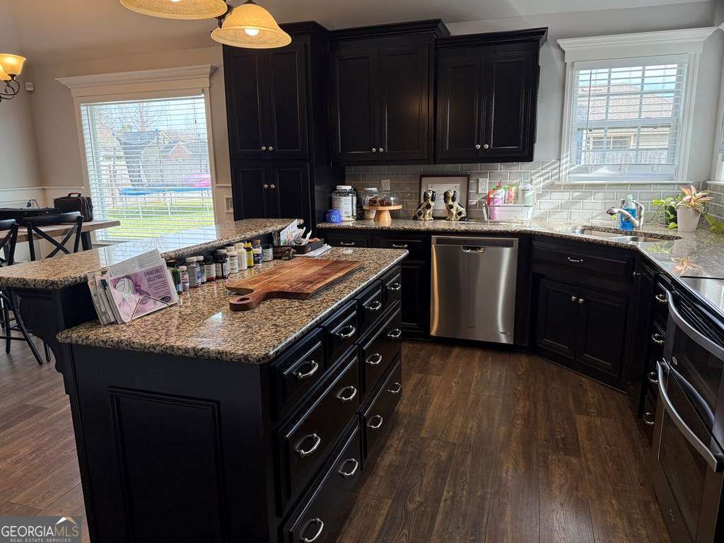 5255 Carlton Ridge Circle Hahira, GA 31632 - Photo 6 of 21 a kitchen with granite countertop a sink a stove and cabinets