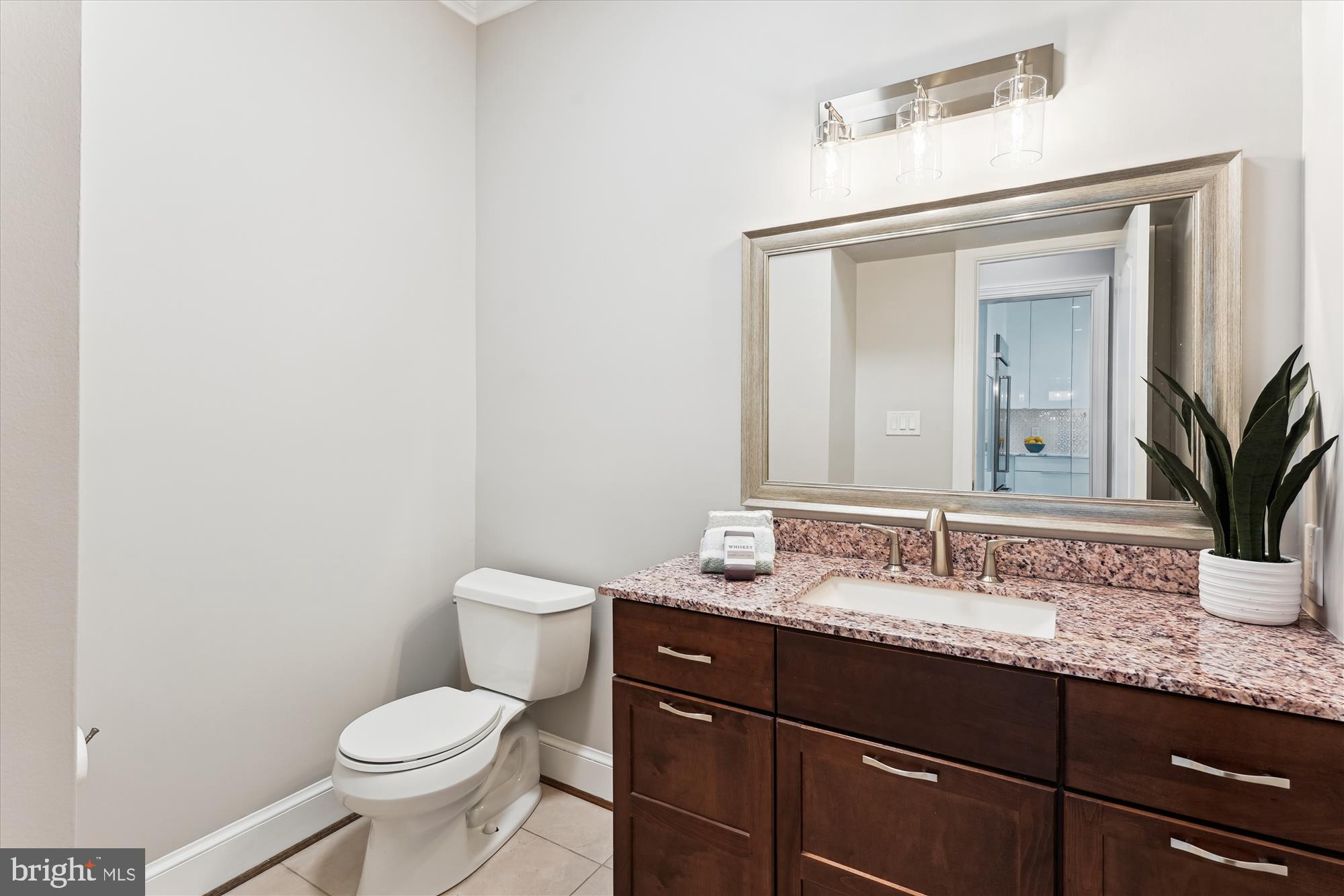 9801 Hall Road Potomac, MD 20854 - Photo 23 of 79 a bathroom with a granite countertop sink a toilet and a mirror
