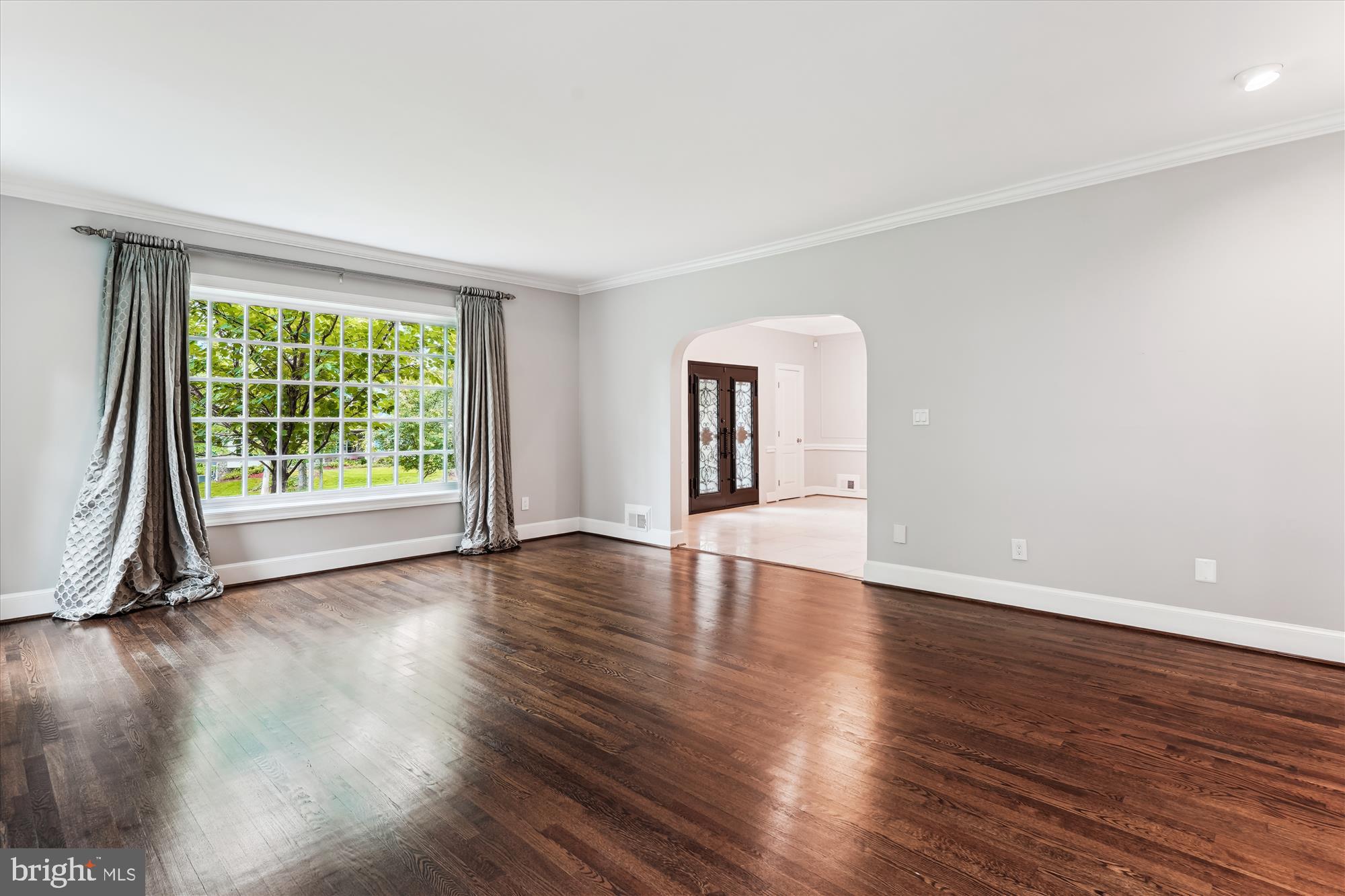 9801 Hall Road Potomac, MD 20854 - Photo 8 of 79 a view of an empty room with wooden floor and a window