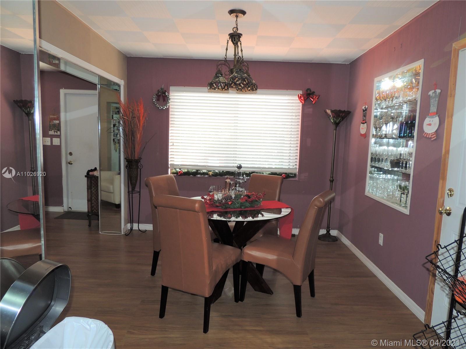 Westwood Lakes Miami, FL 33165 - Photo 13 of 29 a view of a dining room with furniture window and wooden floor