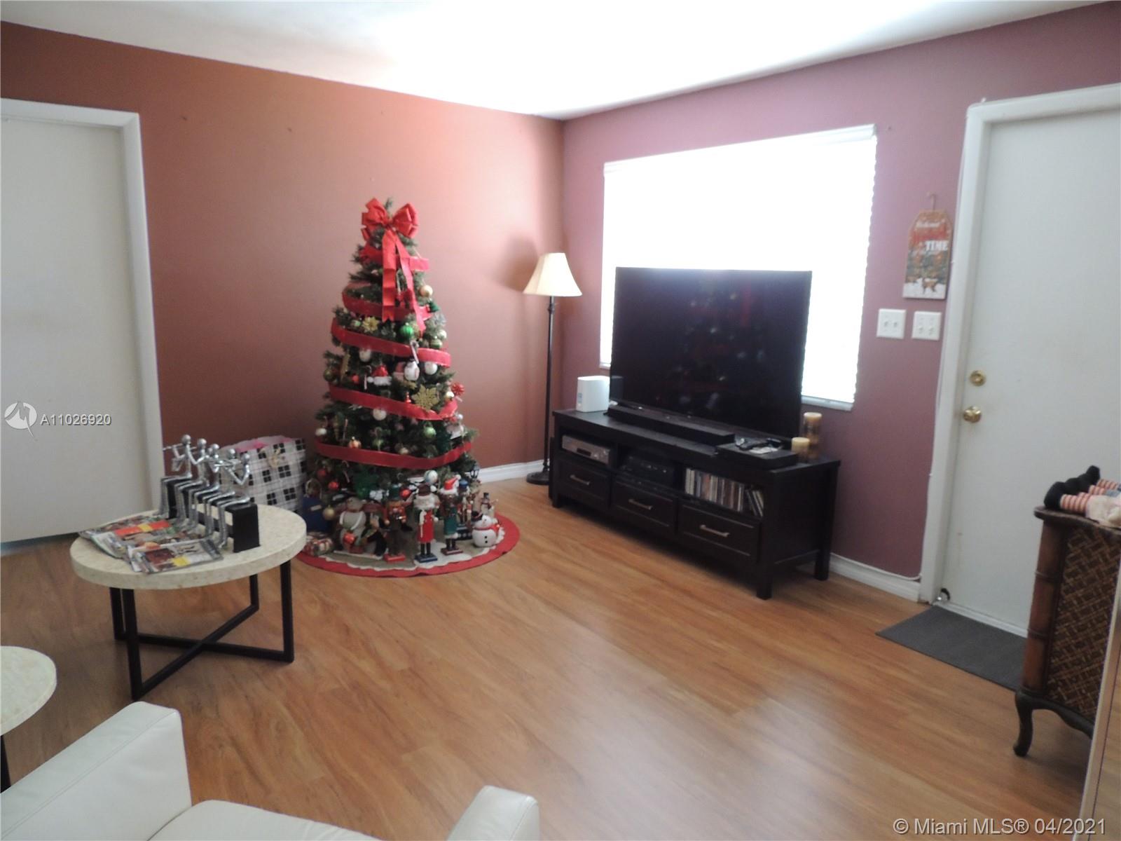Westwood Lakes Miami, FL 33165 - Photo 14 of 29 a living room with furniture and a flat screen tv