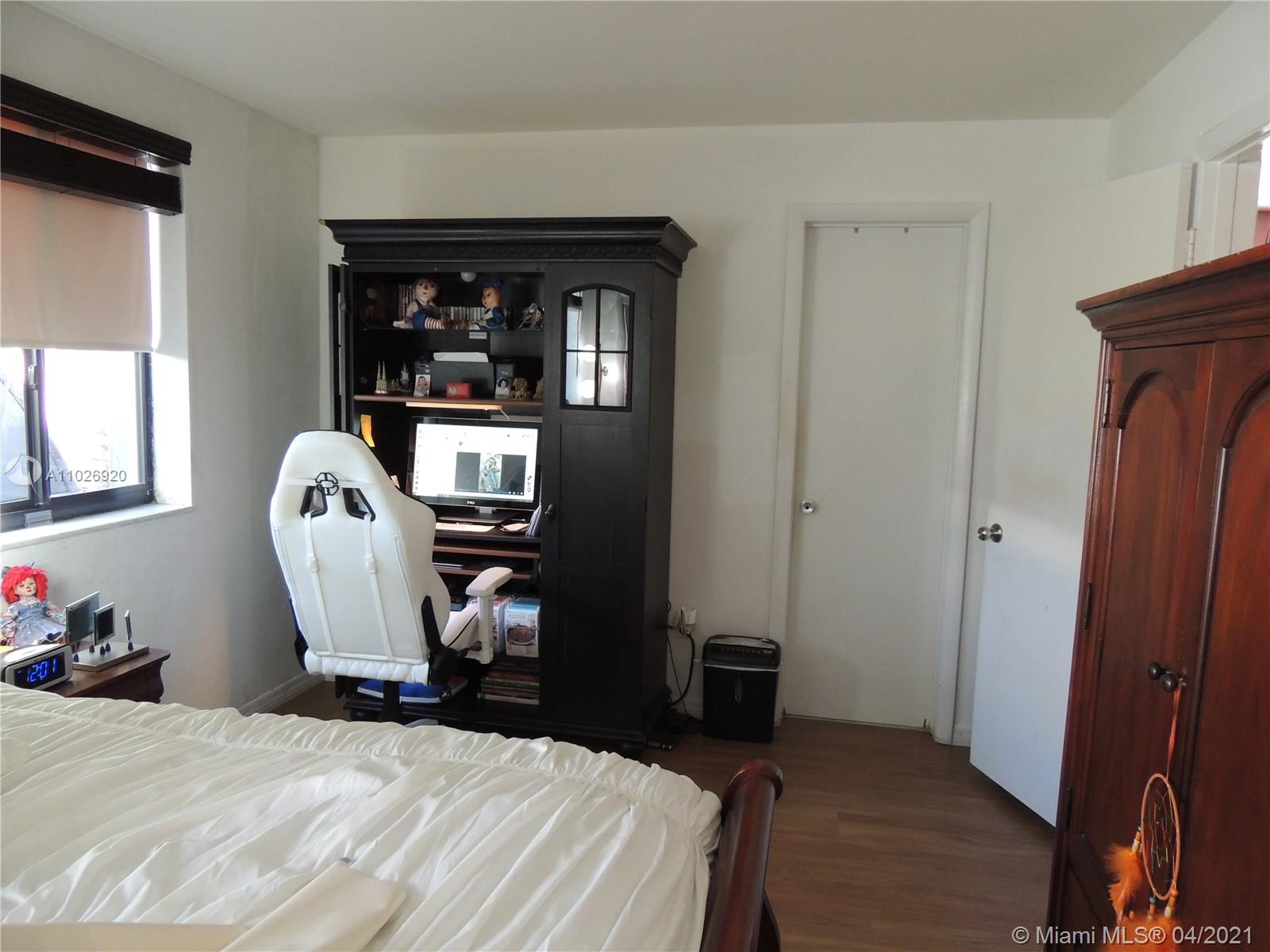 Westwood Lakes Miami, FL 33165 - Photo 17 of 29 a bedroom with a bed and wooden floor