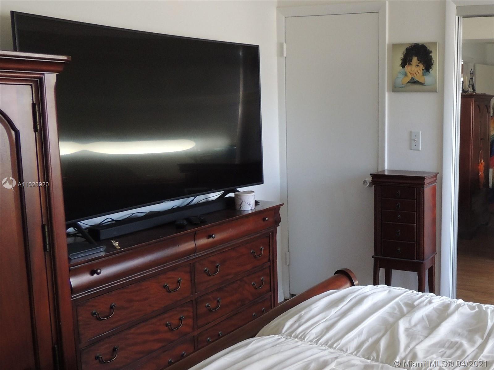 Westwood Lakes Miami, FL 33165 - Photo 18 of 29 a bedroom with a bed and a flat tv screen