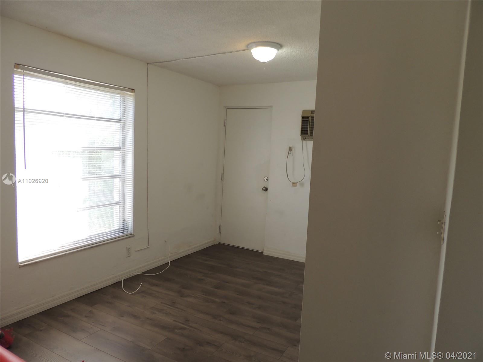 Westwood Lakes Miami, FL 33165 - Photo 20 of 29 an empty room with wooden floor and windows