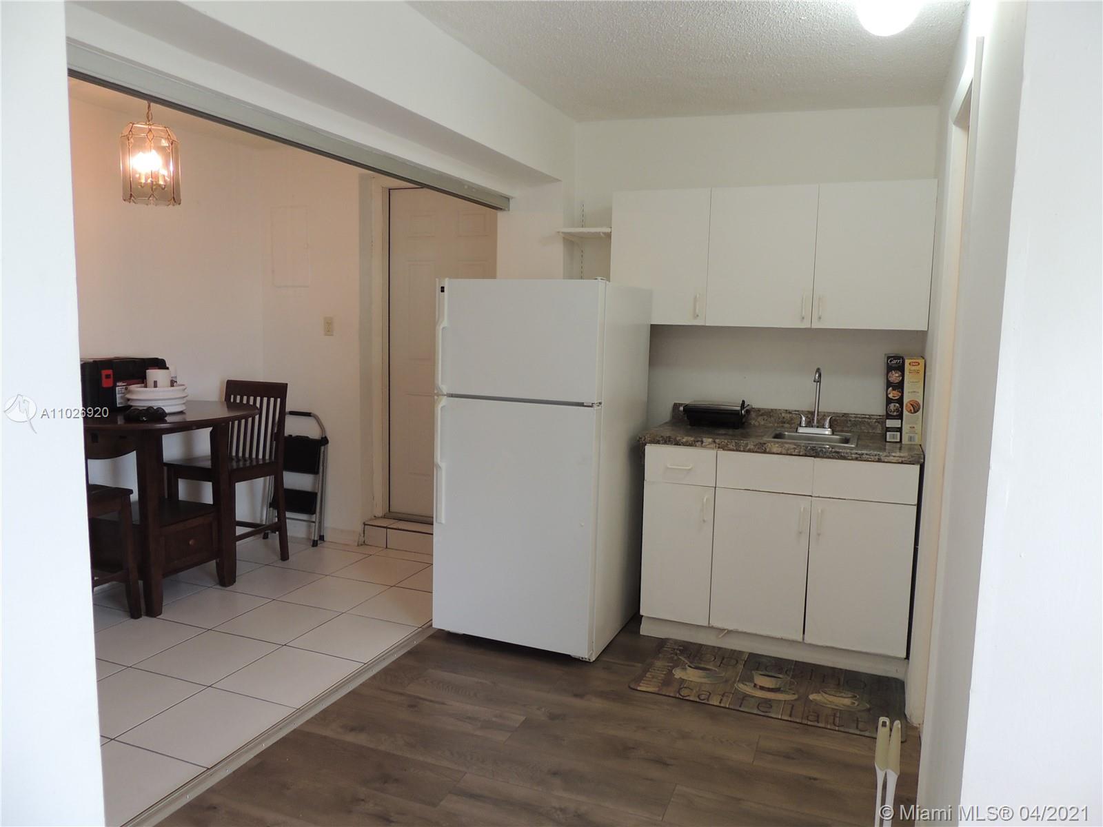 Westwood Lakes Miami, FL 33165 - Photo 21 of 29 a kitchen with a refrigerator a table and chairs