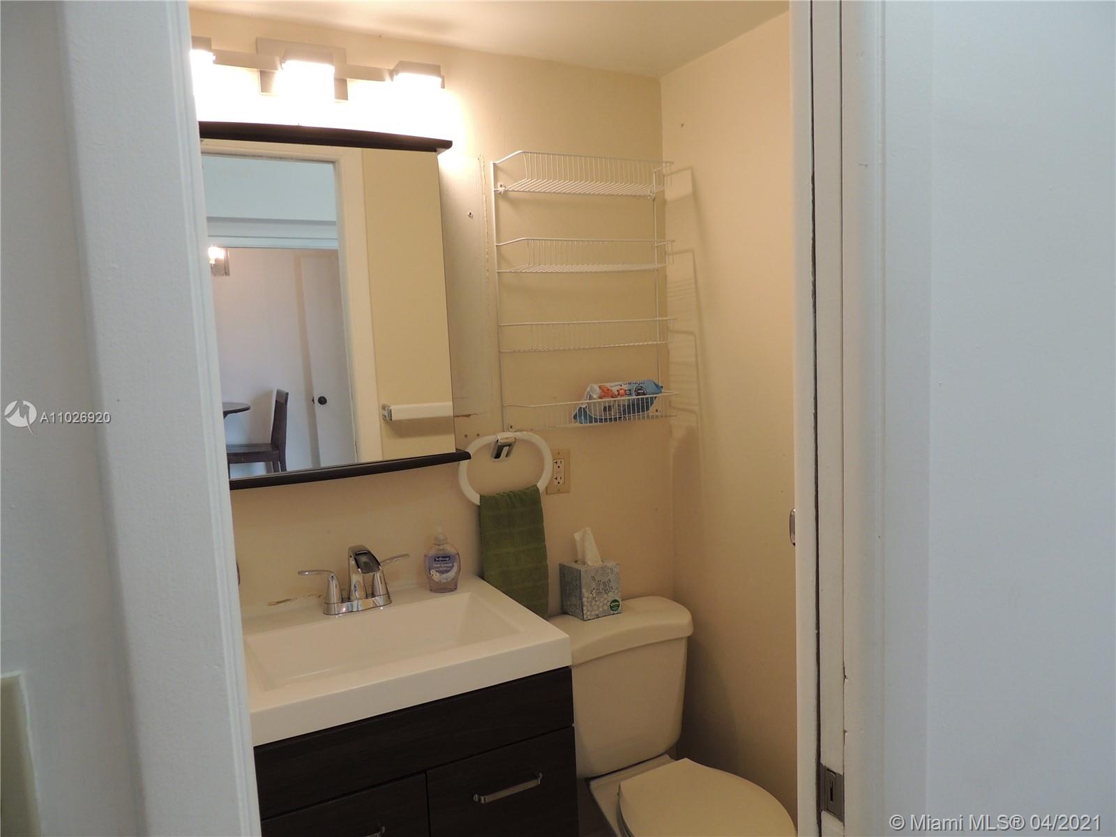 Westwood Lakes Miami, FL 33165 - Photo 25 of 29 a bathroom with a sink a toilet and a mirror