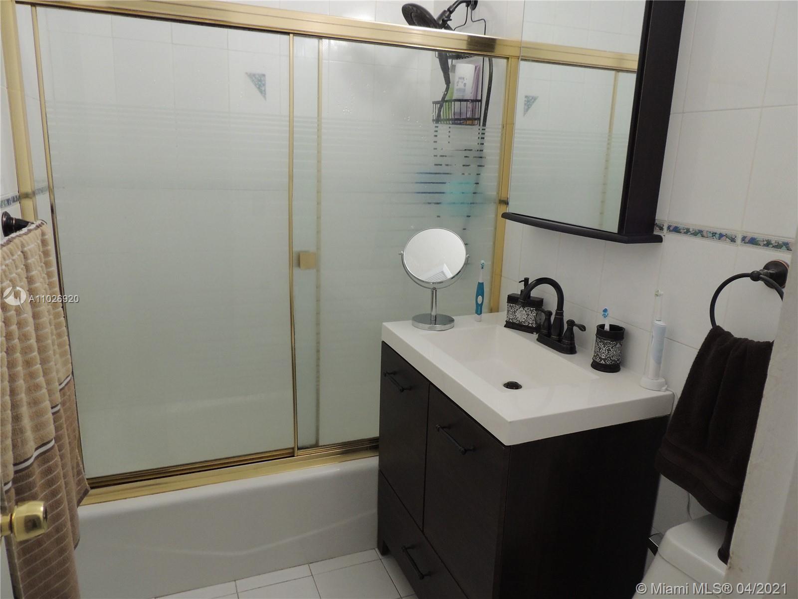 Westwood Lakes Miami, FL 33165 - Photo 7 of 29 a bathroom with a sink mirror and vanity