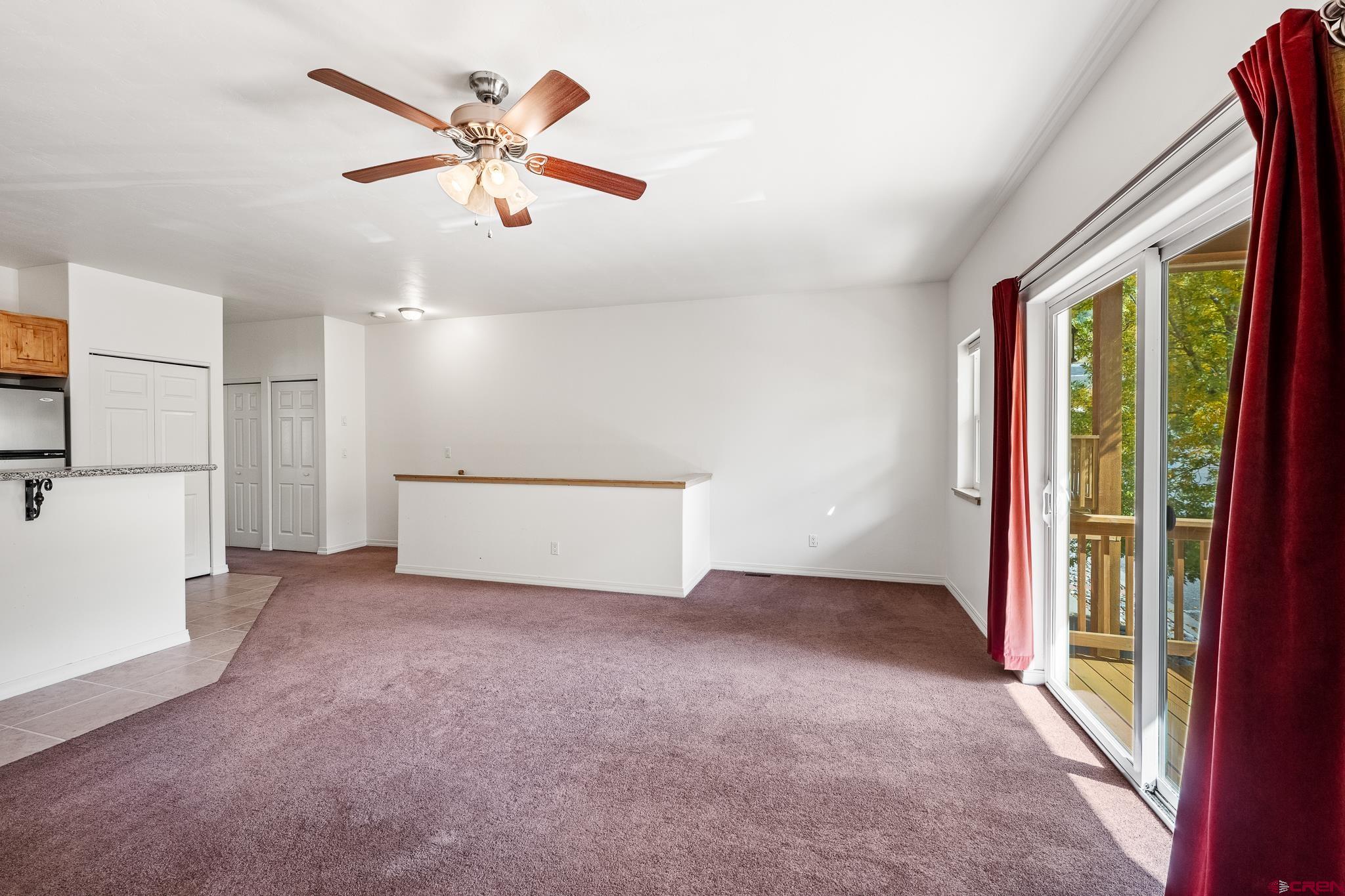 33 Cedar Ridge Way, Unit 3 Durango, CO 81301 - Photo 16 of 31 an empty room with ceiling fan and windows