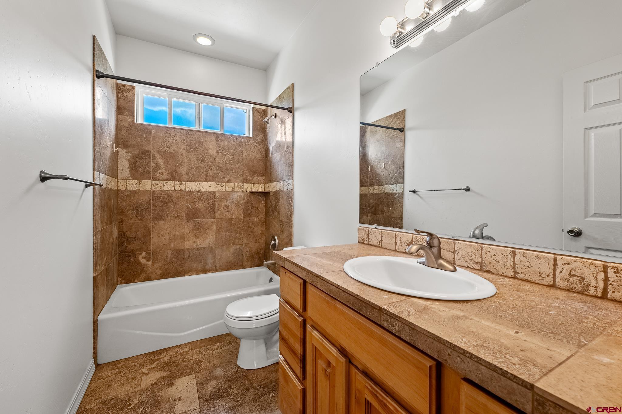33 Cedar Ridge Way, Unit 3 Durango, CO 81301 - Photo 18 of 31 a bathroom with a granite countertop sink toilet and shower