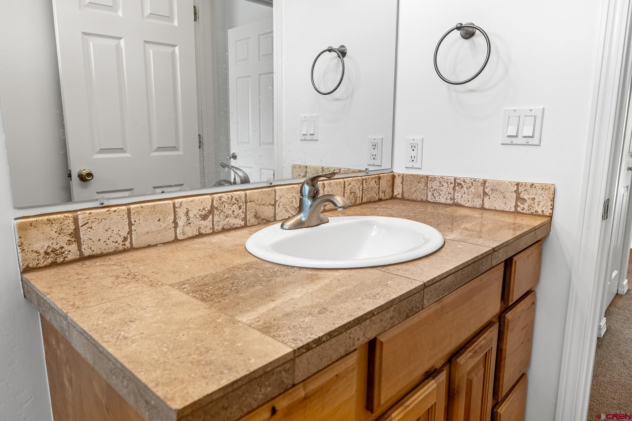 33 Cedar Ridge Way, Unit 3 Durango, CO 81301 - Photo 20 of 31 a bathroom with a sink and mirror