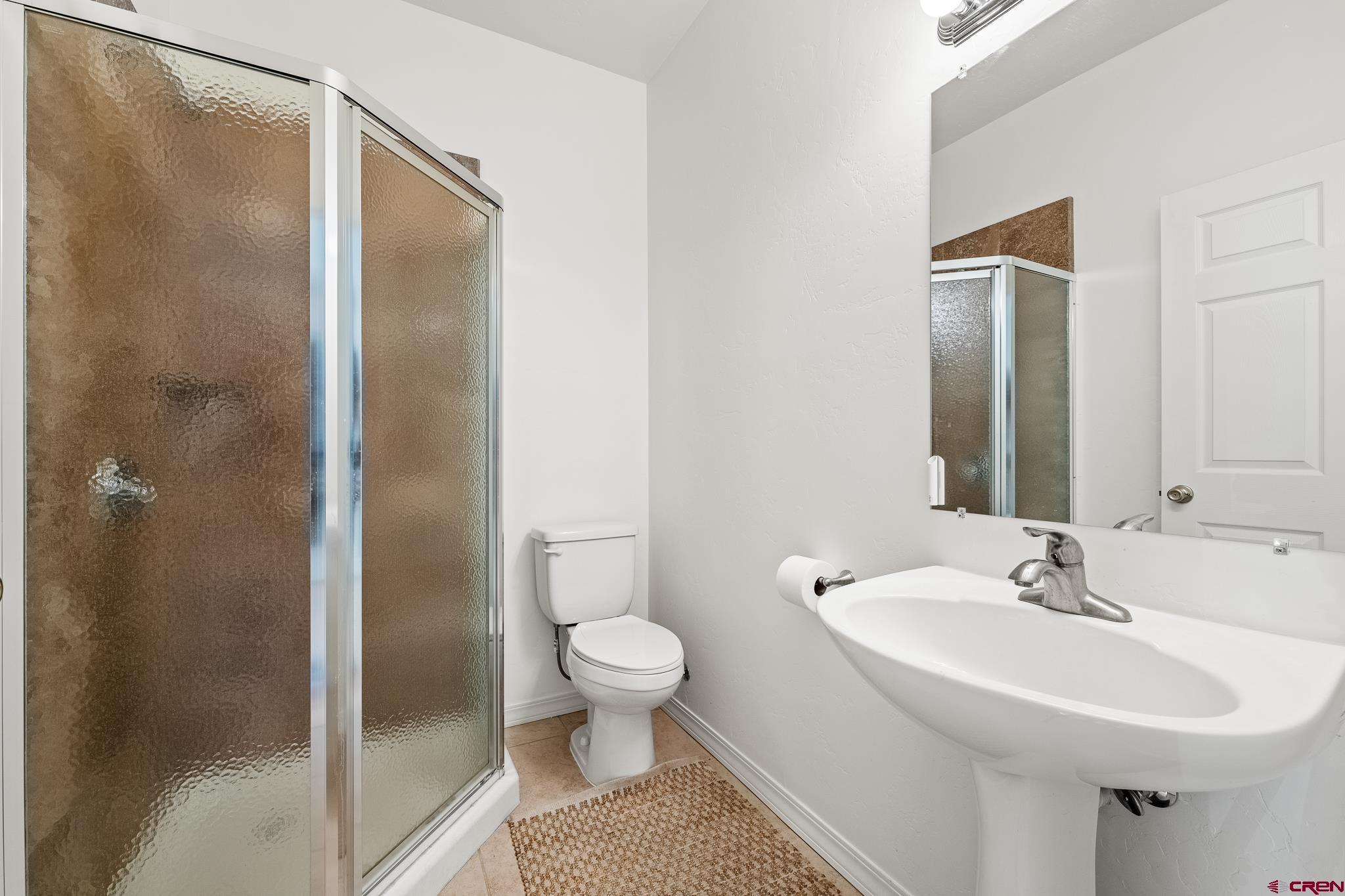 33 Cedar Ridge Way, Unit 3 Durango, CO 81301 - Photo 29 of 31 a bathroom with a sink toilet and shower