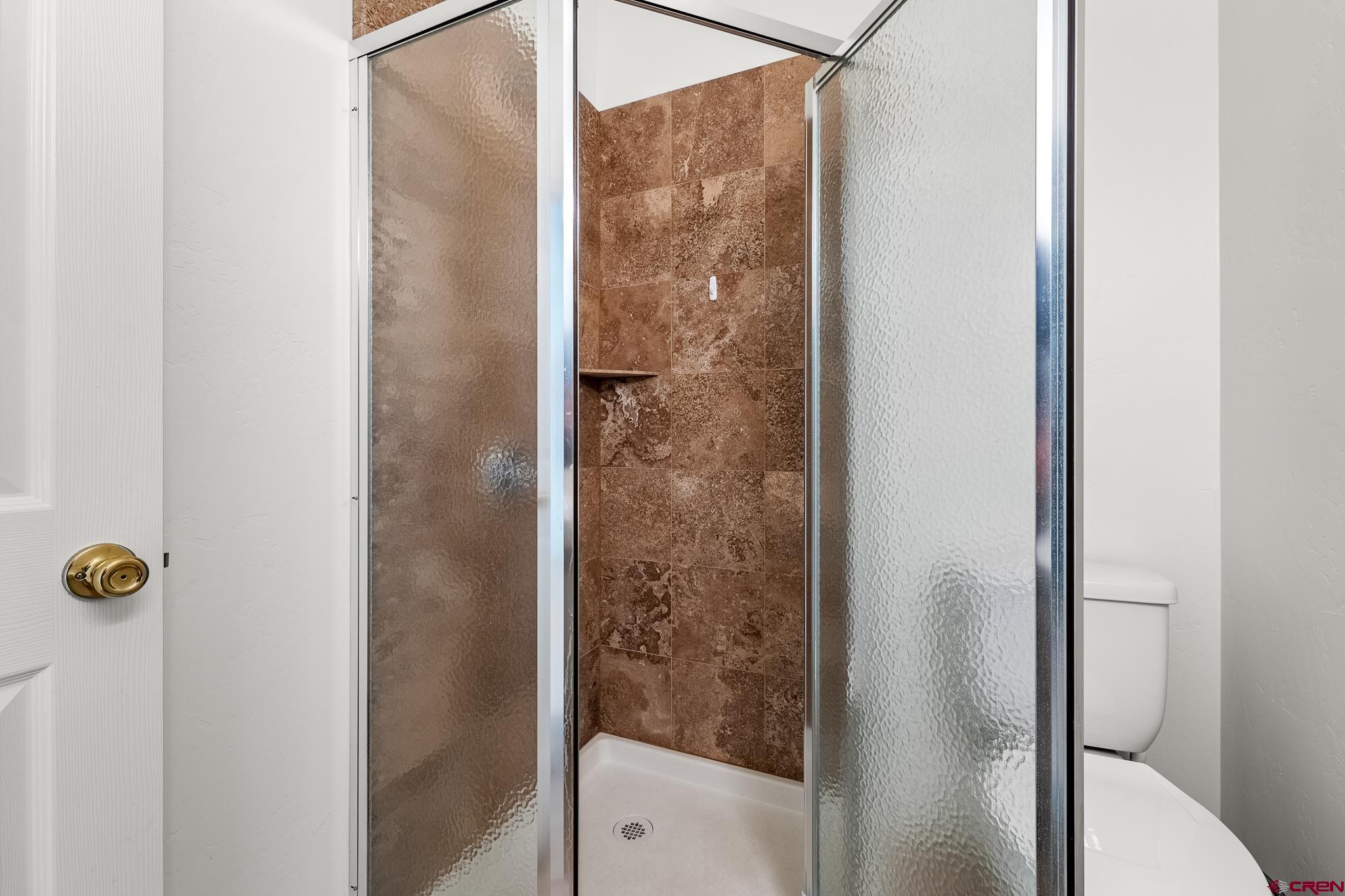 33 Cedar Ridge Way, Unit 3 Durango, CO 81301 - Photo 30 of 31 a bathroom with a glass shower door