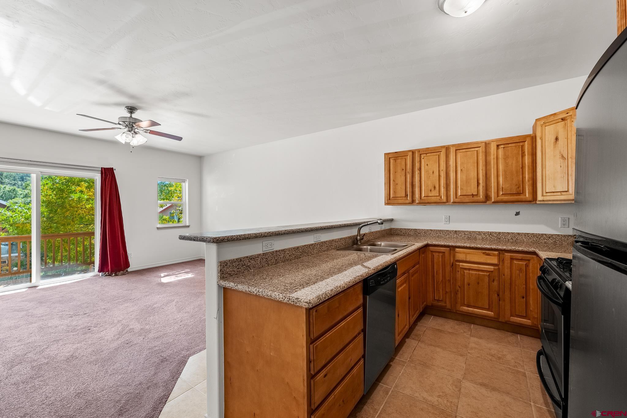 33 Cedar Ridge Way, Unit 3 Durango, CO 81301 - Photo 9 of 31 a kitchen with a sink stove and cabinets