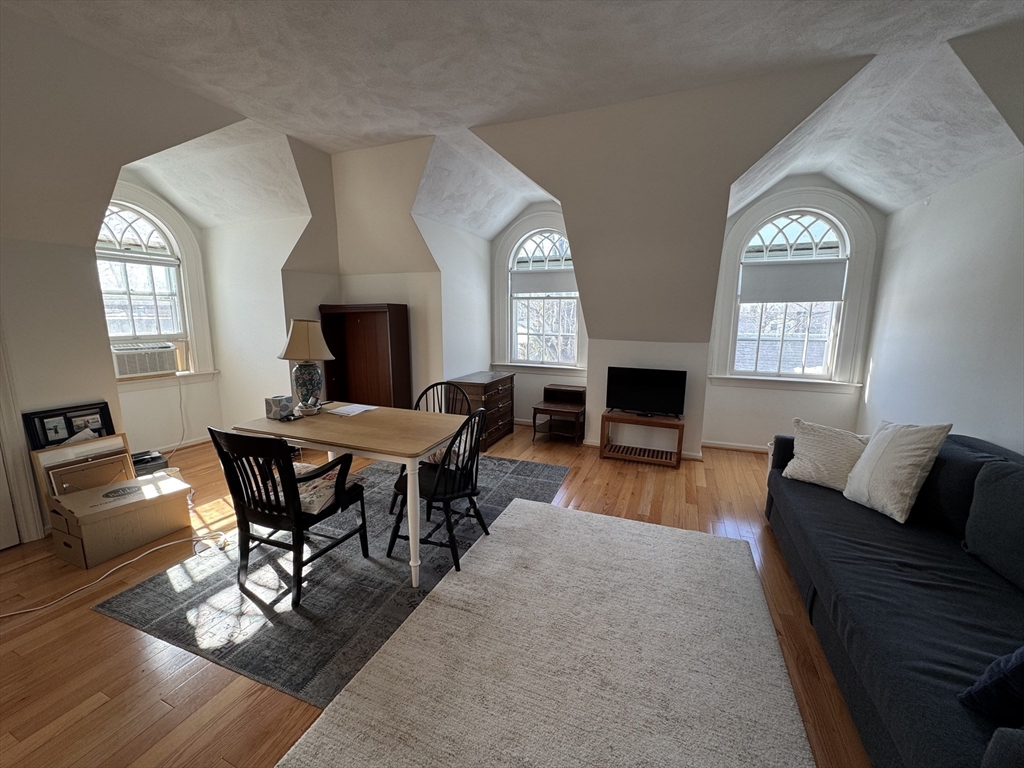 600 Washington Street, Unit 7 Wellesley, MA 02482 - Photo 2 of 13 a living room with furniture and a fireplace