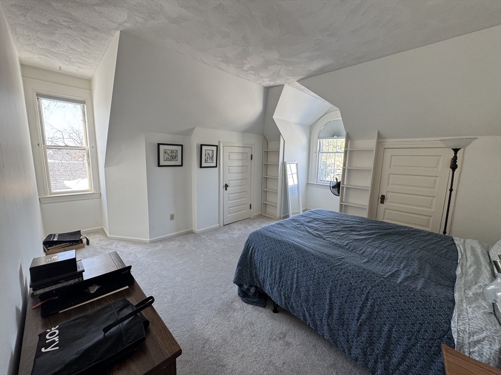 600 Washington Street, Unit 7 Wellesley, MA 02482 - Photo 4 of 13 a bedroom with a bed and a dresser