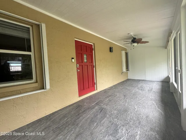 a view of a hallway with wooden floor and a fireplace