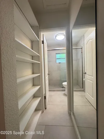 a bathroom with a glass shower door