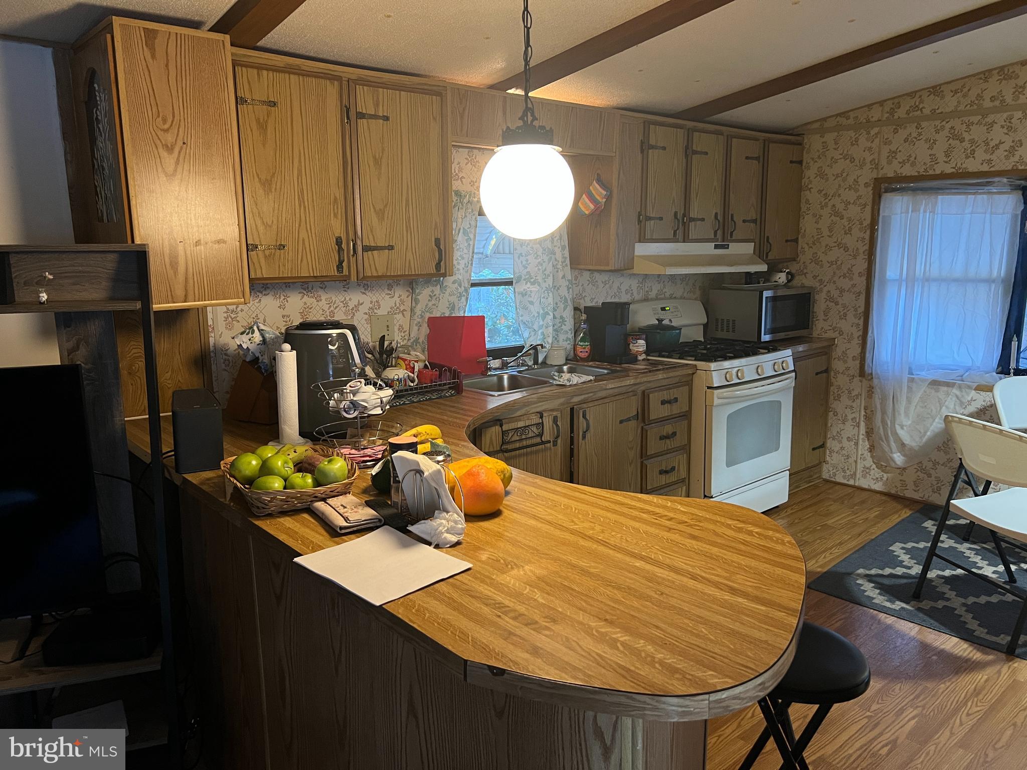 576 West Forest Grove Road Vineland, NJ 08360 - Photo 3 of 14 a kitchen with a table chairs and a refrigerator
