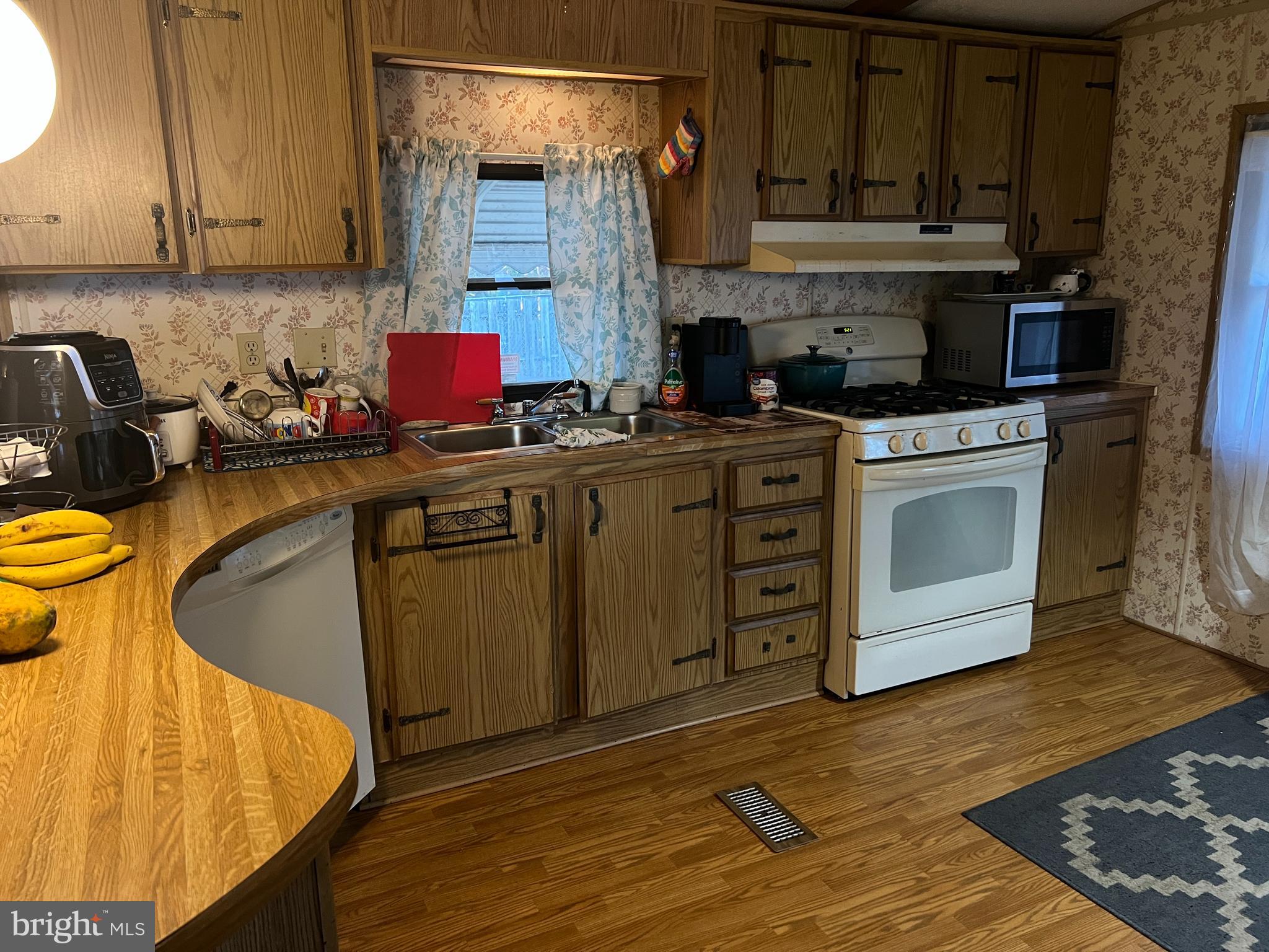 576 West Forest Grove Road Vineland, NJ 08360 - Photo 5 of 14 a kitchen with stainless steel appliances granite countertop a stove a sink and a microwave