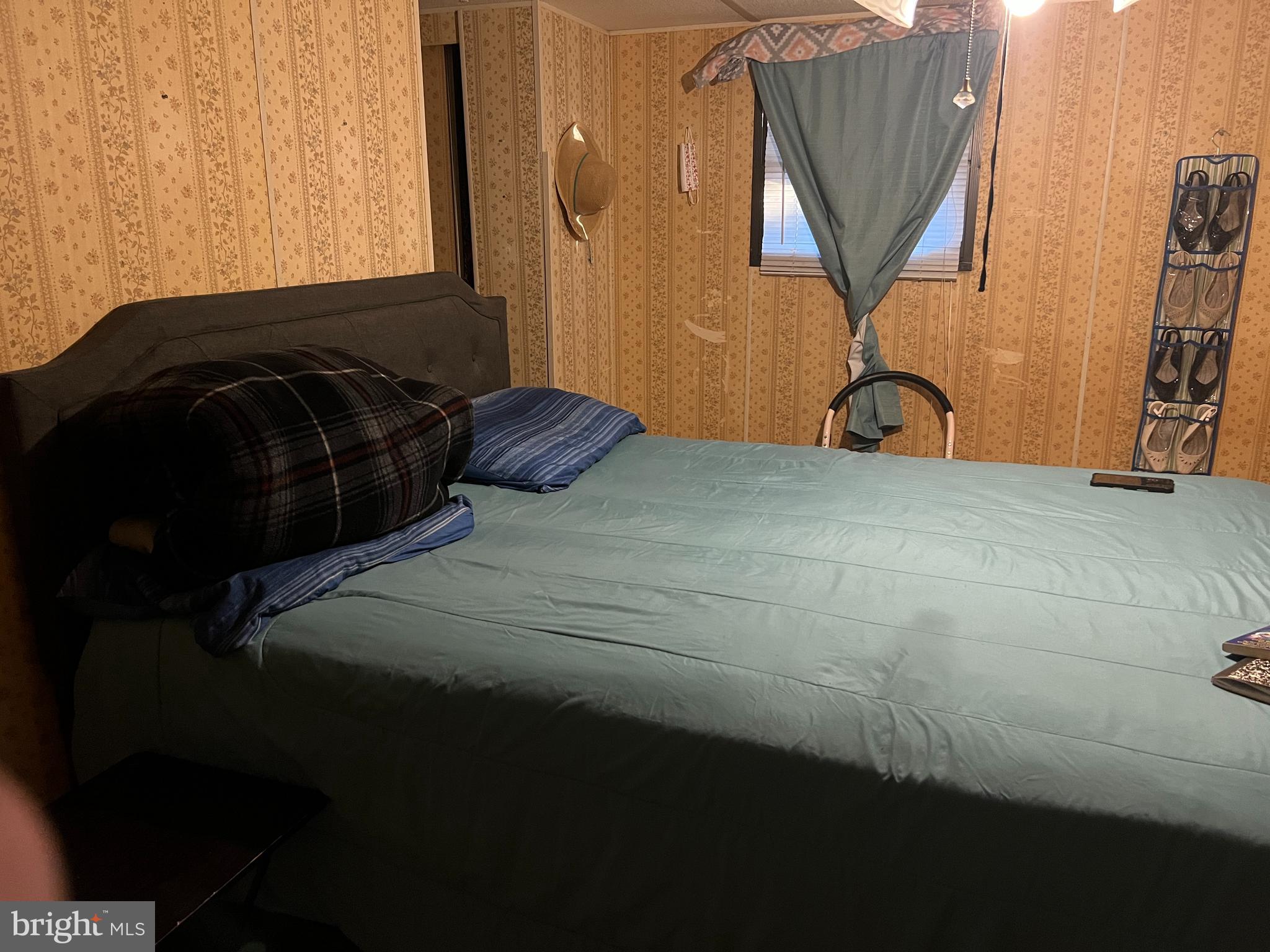 576 West Forest Grove Road Vineland, NJ 08360 - Photo 6 of 14 a bed sitting in a bedroom next to a window and a bicycle