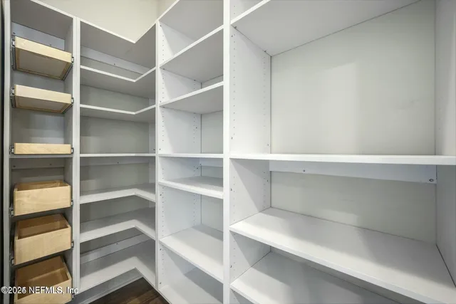 a view of a lake with boats and trees in the background